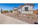 Beautiful front yard with landscaped gravel, plants, and a paver driveway at 12022 W Marguerite Ave, Avondale, AZ 85323