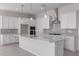 Modern kitchen featuring white cabinets, stainless steel appliances, and a large center island at 12022 W Marguerite Ave, Avondale, AZ 85323