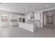 Bright kitchen featuring a center island, stainless steel appliances, and modern pendant lighting at 12022 W Marguerite Ave, Avondale, AZ 85323