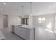 Gourmet kitchen with white cabinetry and stainless steel appliances, perfect for entertaining at 12022 W Marguerite Ave, Avondale, AZ 85323