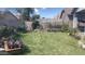 Expansive backyard with a block fence, garden, mature landscaping, and lush lawn, creating a private outdoor retreat at 13001 W Aster Dr, El Mirage, AZ 85335