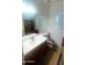 Bright bathroom featuring a single sink, and unique animal print rugs and toilet seat cover at 13001 W Aster Dr, El Mirage, AZ 85335