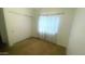 Bedroom with a sliding door closet and a large window for natural lighting at 13001 W Aster Dr, El Mirage, AZ 85335