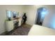 Well-lit bedroom featuring a makeup vanity, area rug, and a neutral color scheme at 13001 W Aster Dr, El Mirage, AZ 85335