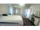 Well-lit bedroom featuring a makeup vanity, area rug, and a neutral color scheme at 13001 W Aster Dr, El Mirage, AZ 85335