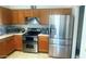 Functional kitchen with wood cabinets and stainless steel appliances at 13001 W Aster Dr, El Mirage, AZ 85335