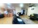 Open concept living room with tile flooring, neutral tones, and access to the kitchen at 13001 W Aster Dr, El Mirage, AZ 85335