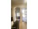 Bright living room featuring an archway, tiled floor, and large sliding glass door at 13001 W Aster Dr, El Mirage, AZ 85335