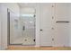 Shower enclosure featuring frameless glass, awning window, neutral tiling, and matte black hardware at 13448 W Auburn Dr, Peoria, AZ 85383