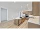 This kitchen showcases custom cabinets, an island, tile backsplash, stainless appliances and room to entertain at 13448 W Auburn Dr, Peoria, AZ 85383