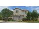 Charming two-story home featuring a well-maintained landscaped yard with lush greenery and a classic tile roof at 13525 N 158Th Ave, Surprise, AZ 85379