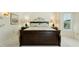Bedroom with neutral paint, decorative lamps, and a dark wood bed frame at 14111 W Cavalcade Dr, Sun City West, AZ 85375