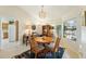Charming dining room with a chandelier, wooden table, and a view into the kitchen area at 14111 W Cavalcade Dr, Sun City West, AZ 85375