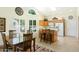 Bright dining area with a view of the kitchen, showcasing natural light and modern design at 14111 W Cavalcade Dr, Sun City West, AZ 85375