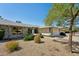 Attractive home exterior with brick accents, desert landscaping, and a well-maintained lawn at 14111 W Cavalcade Dr, Sun City West, AZ 85375