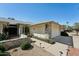 Beautiful home exterior with a well-maintained walkway, lovely landscaping, and an attached two-car garage at 14111 W Cavalcade Dr, Sun City West, AZ 85375