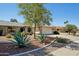 Charming single-story home with well-manicured landscaping and desert-friendly plants in the front yard at 14111 W Cavalcade Dr, Sun City West, AZ 85375