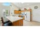 Bright kitchen features updated appliances, white countertops, skylight, and breakfast bar seating at 14111 W Cavalcade Dr, Sun City West, AZ 85375