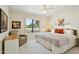 Bedroom with a large window, cozy chair, Southwestern decor, and neutral tones at 14111 W Cavalcade Dr, Sun City West, AZ 85375