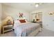 Neutral bedroom features mirrored closet, Southwestern decor, and views to the backyard at 14111 W Cavalcade Dr, Sun City West, AZ 85375