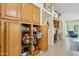 Spacious pantry with roll-out shelves provides ample storage in the home's kitchen area at 14111 W Cavalcade Dr, Sun City West, AZ 85375
