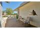Inviting outdoor patio with seating, mature landscaping, and decorative wall art at 14111 W Cavalcade Dr, Sun City West, AZ 85375