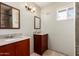 Bathroom with double sink, wood cabinets, and tiled flooring at 1434 W Meseto Ave, Mesa, AZ 85202