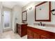 Bright bathroom featuring double sink vanity with granite countertops and wood cabinets at 1434 W Meseto Ave, Mesa, AZ 85202