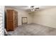 Spacious bedroom showcasing neutral carpets, ceiling fan and a wooden dresser at 1434 W Meseto Ave, Mesa, AZ 85202