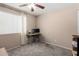 Bedroom with a desk, fan, and neutral carpet at 1434 W Meseto Ave, Mesa, AZ 85202