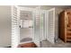 Bedroom featuring an open door leading to the patio and neutral carpets at 1434 W Meseto Ave, Mesa, AZ 85202