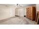 Bedroom featuring neutral carpets, ceiling fan, shutters and a wooden dresser at 1434 W Meseto Ave, Mesa, AZ 85202