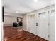 Inviting entryway featuring rich hardwood floors and views into the living area at 1434 W Meseto Ave, Mesa, AZ 85202