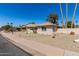 Single-story home with a charming desert landscape and well-maintained front yard at 1434 W Meseto Ave, Mesa, AZ 85202