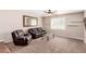 Comfortable living room with plush seating, soft carpet, and ample natural light at 1434 W Meseto Ave, Mesa, AZ 85202