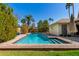 Inviting backyard pool with brick surround, lush landscaping, and clear blue water at 1434 W Meseto Ave, Mesa, AZ 85202