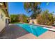 Lush backyard pool with manicured landscaping and plenty of space for entertaining and relaxing at 1434 W Meseto Ave, Mesa, AZ 85202