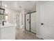 Modern bathroom features double sinks, walk-in closet, and glass shower with black trim at 15584 S 180Th Ln, Goodyear, AZ 85338