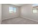 Bright bedroom featuring neutral walls, carpet flooring, and natural light from two windows at 15584 S 180Th Ln, Goodyear, AZ 85338
