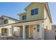 Attractive two-story home with a covered porch, light-colored stucco, and desert landscaping at 15584 S 180Th Ln, Goodyear, AZ 85338