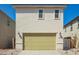 Exterior shot of two-story home with a garage and a bright green garage door at 15584 S 180Th Ln, Goodyear, AZ 85338