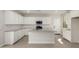 Well-lit kitchen features white cabinets, granite countertops, stainless steel appliances and center island at 15584 S 180Th Ln, Goodyear, AZ 85338