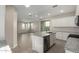 Modern kitchen with stainless steel appliances, granite counters, an island, and an open floor plan at 15584 S 180Th Ln, Goodyear, AZ 85338