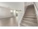 Bright open-concept living room leads to a carpeted staircase with white railings at 15584 S 180Th Ln, Goodyear, AZ 85338