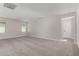 Large bedroom with neutral paint, carpet, window, and door to ensuite bathroom at 15586 S 181St Dr, Goodyear, AZ 85338