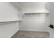 Spacious walk-in closet featuring multiple clothing racks and carpet flooring at 15586 S 181St Dr, Goodyear, AZ 85338