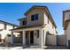 Charming two-story home with a cozy front porch and craftsman architectural details at 15586 S 181St Dr, Goodyear, AZ 85338