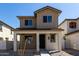 Charming two-story home with a cozy front porch and craftsman architectural details at 15586 S 181St Dr, Goodyear, AZ 85338