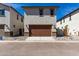 A two-car garage with a large brown door and desert landscaping at 15586 S 181St Dr, Goodyear, AZ 85338