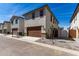 A two-car garage with a large brown door and desert landscaping at 15586 S 181St Dr, Goodyear, AZ 85338